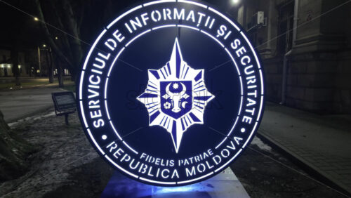 Chisinau, Moldova - January 28, 2026: An illuminated official emblem of the Information and Security Service of Moldova at night