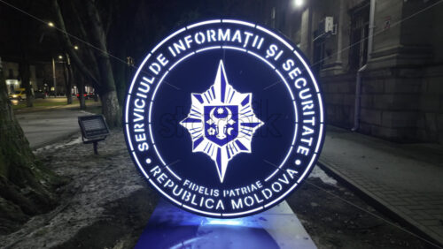 Chisinau, Moldova - January 28, 2026: An illuminated official emblem of the Information and Security Service of Moldova at night