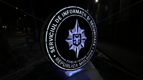 Chisinau, Moldova - January 28, 2026: An illuminated official emblem of the Information and Security Service of Moldova at night