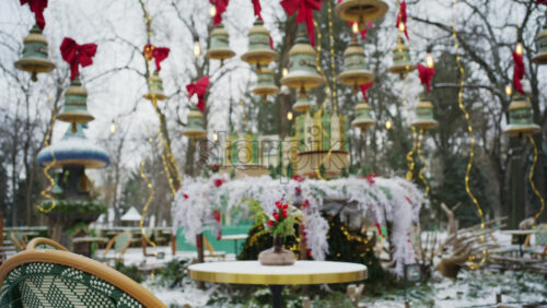 Festive winter decoration with red berries displayed on a table in an outdoor park cafe