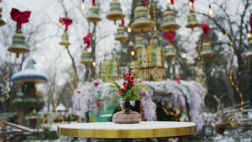 Festive winter decoration with red berries displayed on a table in an outdoor park cafe
