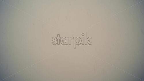 Low angle view of snowflakes falling from the blurry sky