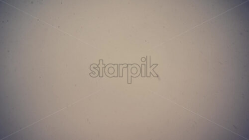 Low angle view of snowflakes falling from the blurry sky