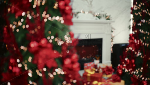 Soft focus view of a Christmas decorated living room with a fireplace, holiday lights, and wrapped gifts