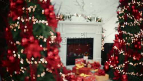 Soft focus view of a Christmas decorated living room with a fireplace, holiday lights, and wrapped gifts