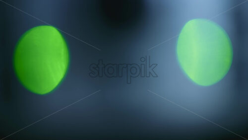 Abstract out of focus green and red lights forming soft circular bokeh shapes