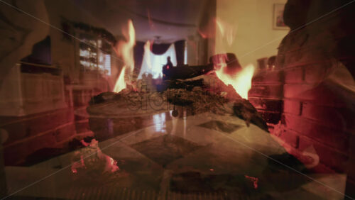 Artistic shot of burning fireplace flames blended with a soft interior reflection, creating a double exposure effect