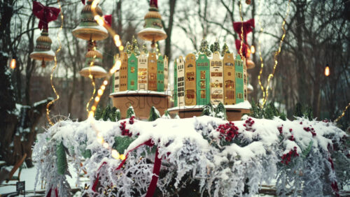 Outdoor cafe decorated with hanging ornaments, lights, and bows during winter