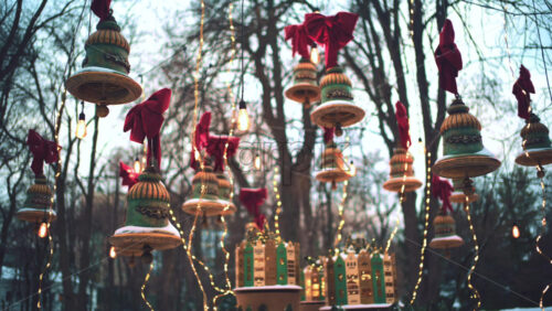 Outdoor cafe decorated with hanging ornaments, lights, and bows during winter