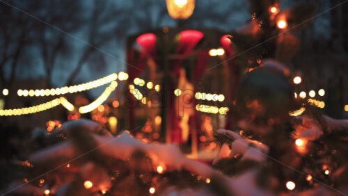Close up of a Christmas ornament hanging on a tree with warm bokeh lights in the background