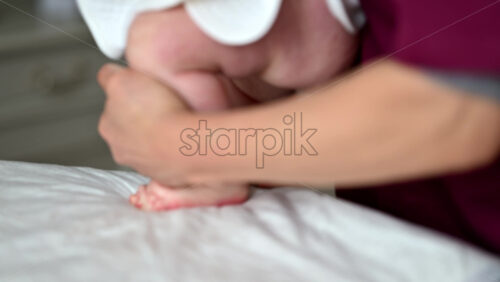 Caregiver doing mobility exercises with a baby