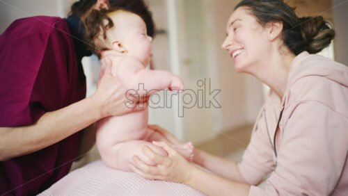 Baby positioned over a stability bal during a gentle physical support routine