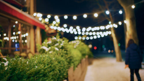 Decorative string lights illuminating a pedestrian walkway at night