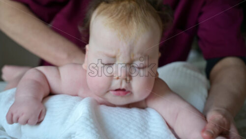 Close up of an infant during tummy time exercise on a soft surface