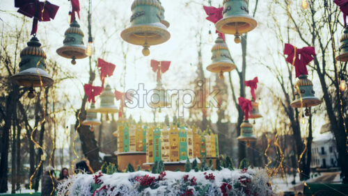 Outdoor cafe decorated with hanging ornaments, lights, and bows during winter