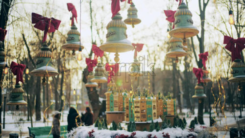 Outdoor cafe decorated with hanging ornaments, lights, and bows during winter