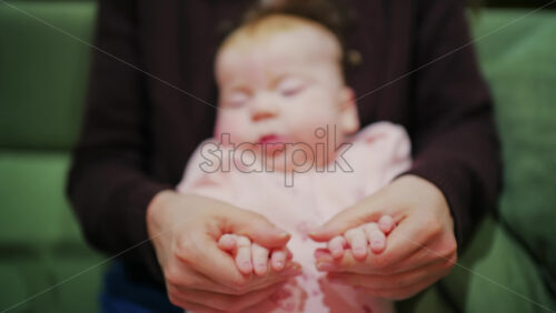 Mother cuddling her baby close to her face in a tender moment