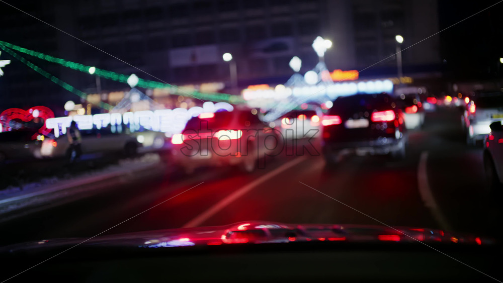 Chisinau, Moldova - January 17, 2026: Cars driving past festive city decorations and illuminated street displays at night