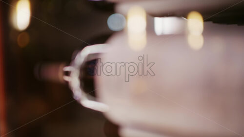 Extreme close up of wine bottles stored horizontally in a rack, with warm lighting and shallow depth of field