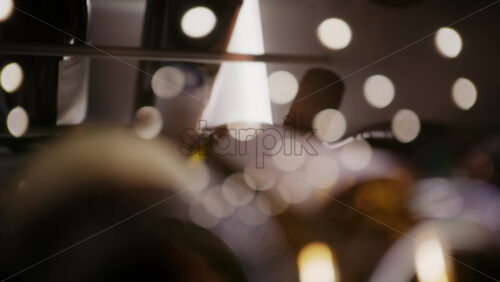 Extreme close up of wine bottles stored horizontally in a rack, with warm lighting and shallow depth of field