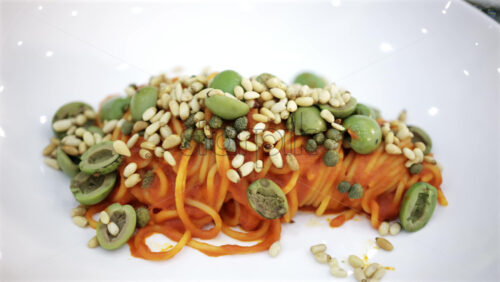 Middle aged man holding a baby in a warmly lit restaurant interior