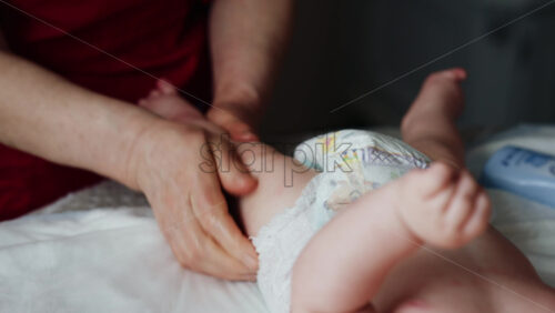 Caregiver doing mobility exercises with a baby