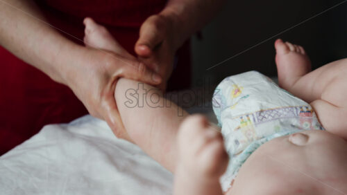 Caregiver doing mobility exercises with a baby