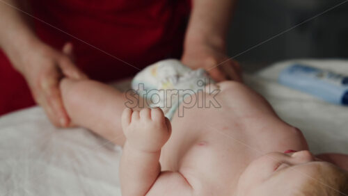 Caregiver doing mobility exercises with a baby