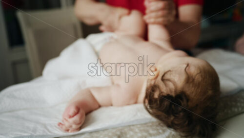 Caregiver doing mobility exercises with a baby