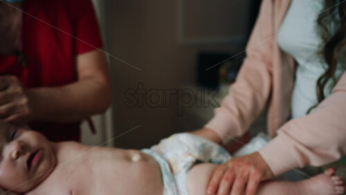 Caregiver doing mobility exercises with a baby