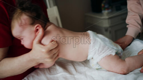 Caregiver doing mobility exercises with a baby