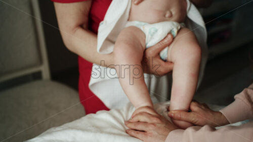 Caregiver doing mobility exercises with a baby