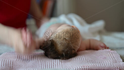 Caregiver doing mobility exercises with a baby
