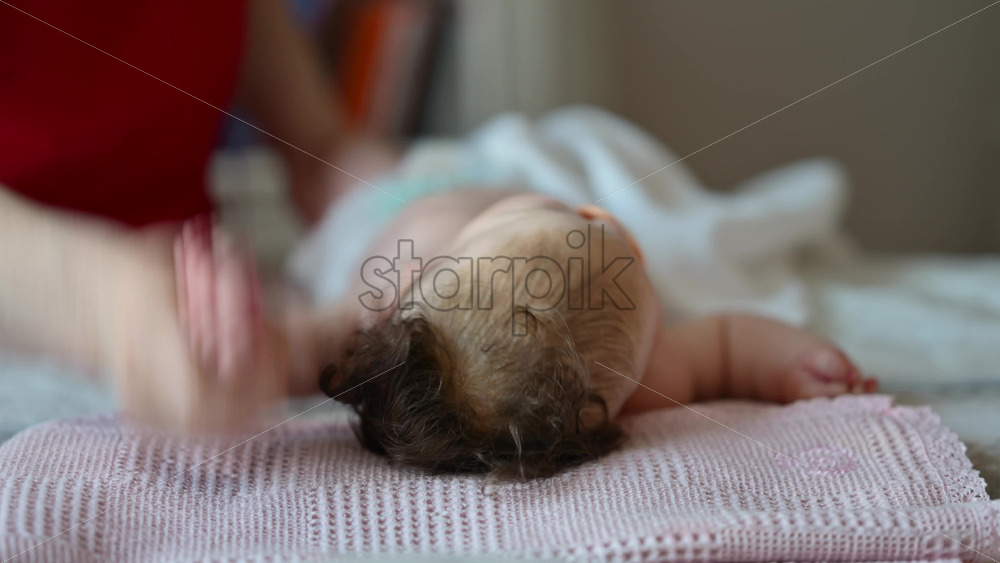 Caregiver doing mobility exercises with a baby