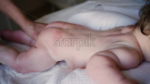 Caregiver doing mobility exercises with a baby