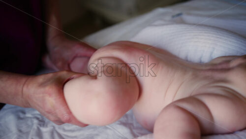 Caregiver doing mobility exercises with a baby