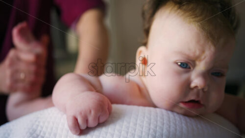 Caregiver doing mobility exercises with a baby