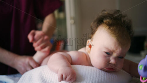Caregiver doing mobility exercises with a baby