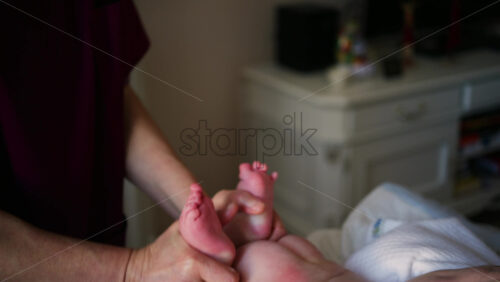 Caregiver doing mobility exercises with a baby