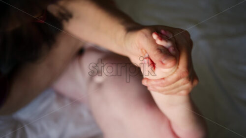 Caregiver doing mobility exercises with a baby