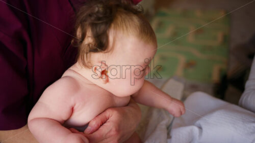 Caregiver doing mobility exercises with a baby