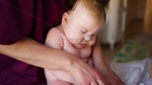 Caregiver doing mobility exercises with a baby