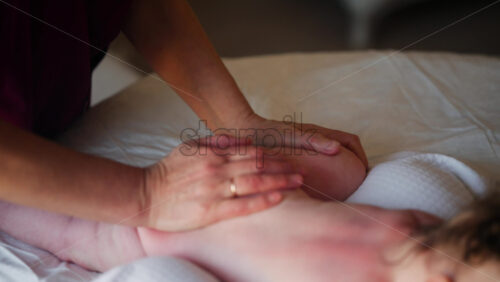 Caregiver doing mobility exercises with a baby
