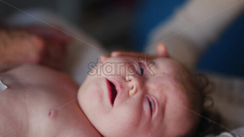 Caregiver doing mobility exercises with a baby
