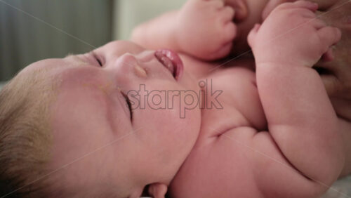 Caregiver doing mobility exercises with a baby