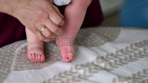 Caregiver doing mobility exercises with a baby