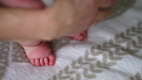 Caregiver doing mobility exercises with a baby