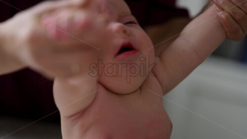 Caregiver doing mobility exercises with a baby