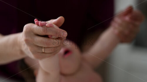 Caregiver doing mobility exercises with a baby