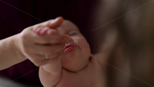 Caregiver doing mobility exercises with a baby